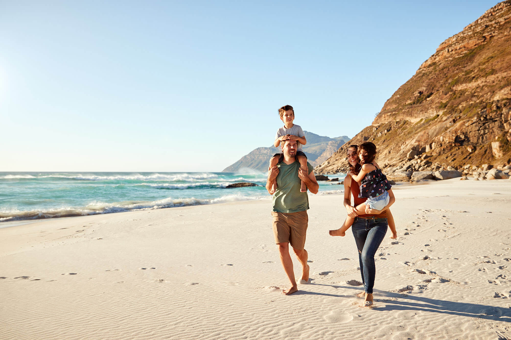 Young family walking on the beach