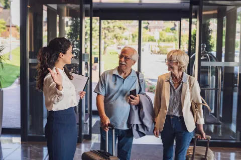 retired couple entering a lobby